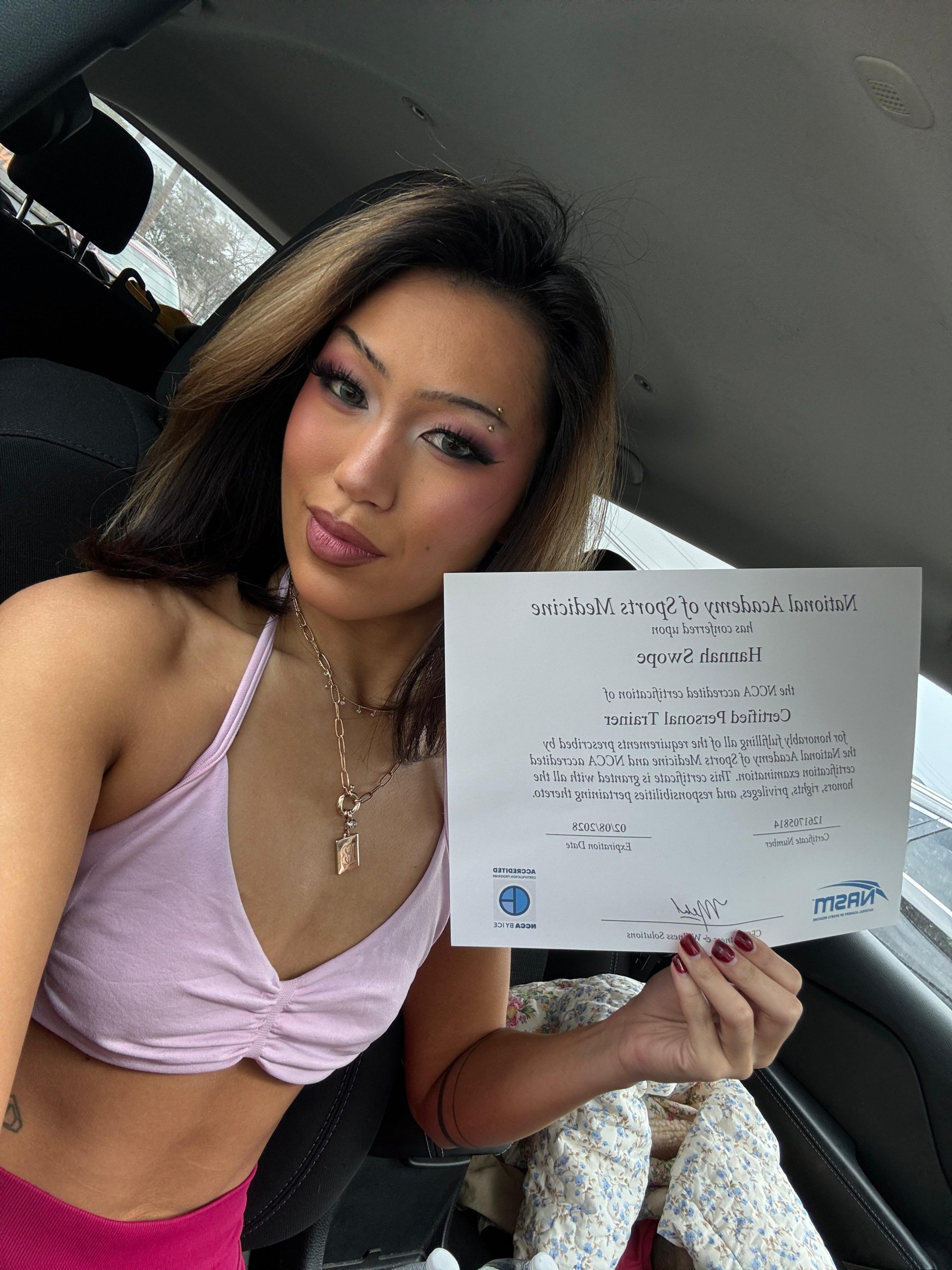 IMG-20260215-WA0002 A proud fitness graduate displaying her official National Academy of Sports Medicine personal trainer certification document.